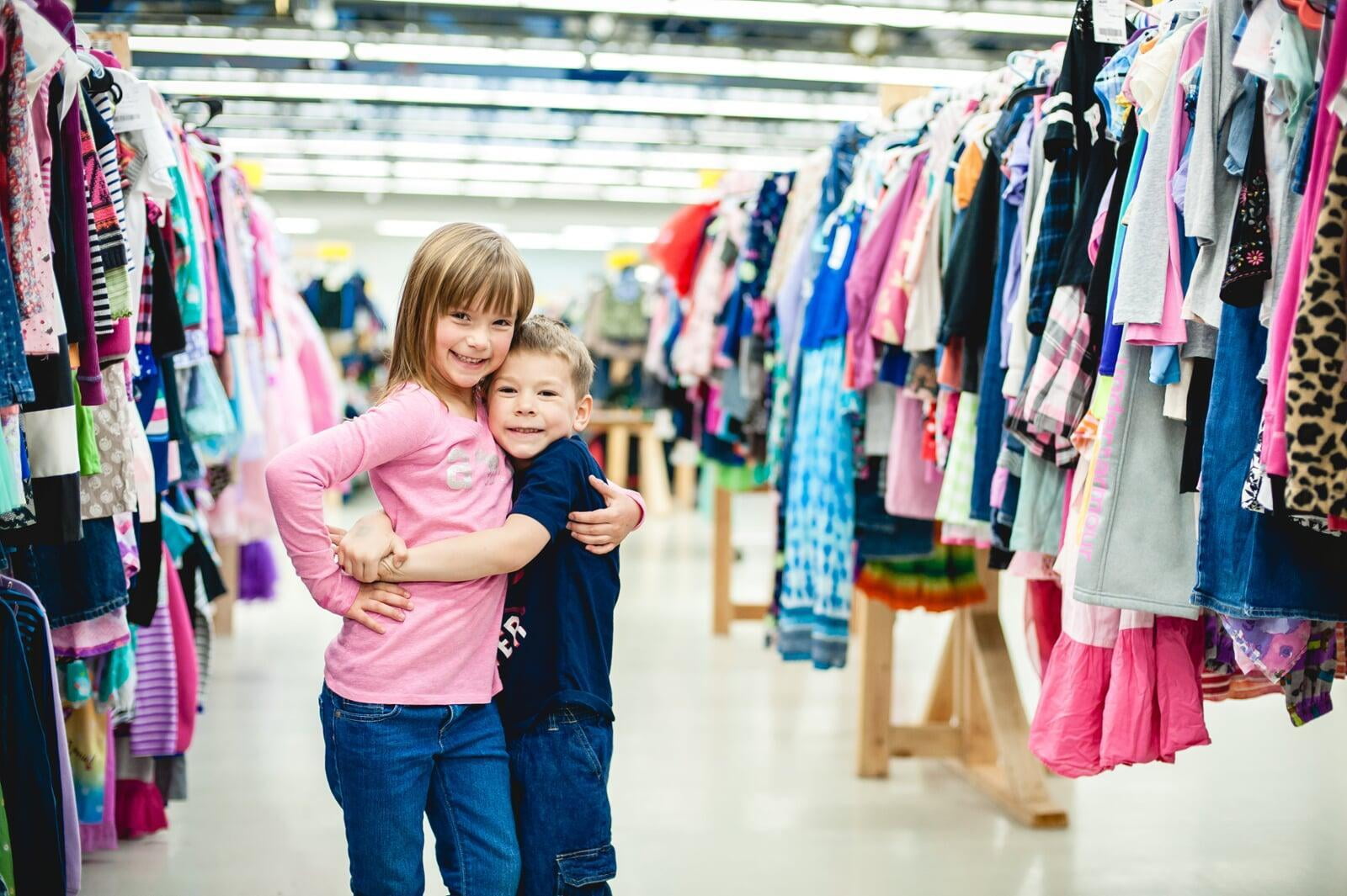 A group of shoppers wearing masks for safety reasons gathers together at the sale to shop.